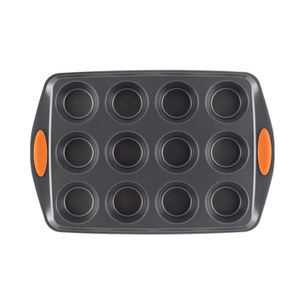 The 12-Cup Nonstick Cupcake & Muffin Pan is designed with twelve circular cups and features orange handles. It's made from heavy gauge steel, ensuring durability and even baking.