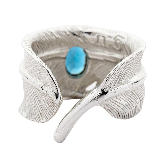 Feather wrap at an angle, matte texture with oxidized recesses and the oval blue topaz bezel set into the band.