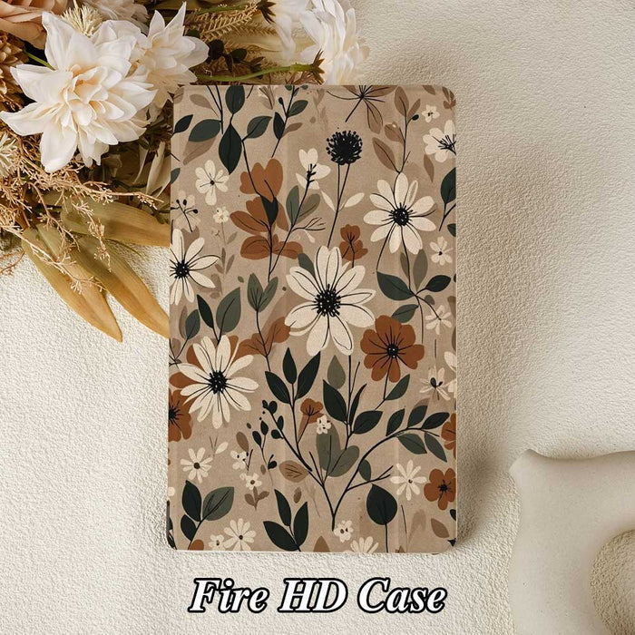 Floral patterned notebook on a textured surface with flowers and a pillow in the background