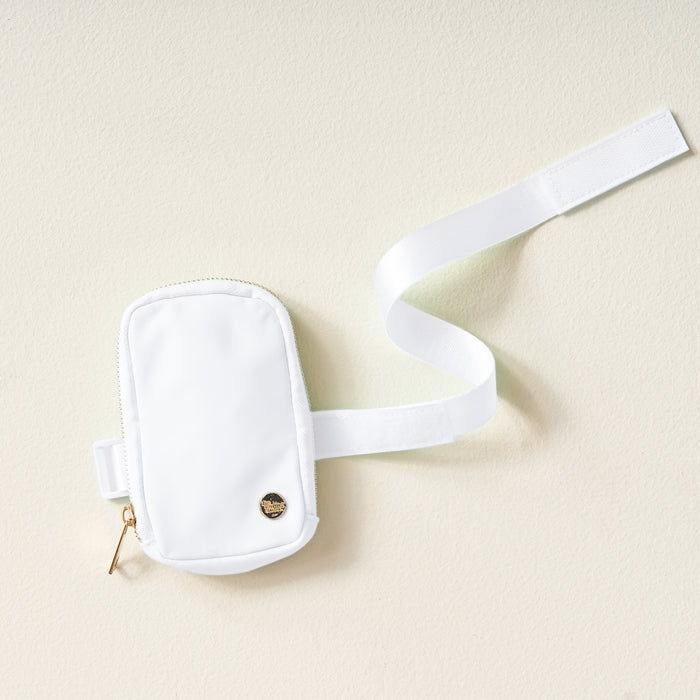 The Darling Effect White Tumbler Fanny Pack features a chic white design with a gold zipper and emblem, plus a long white strap—water-resistant and ideal for carrying essentials on daily adventures.