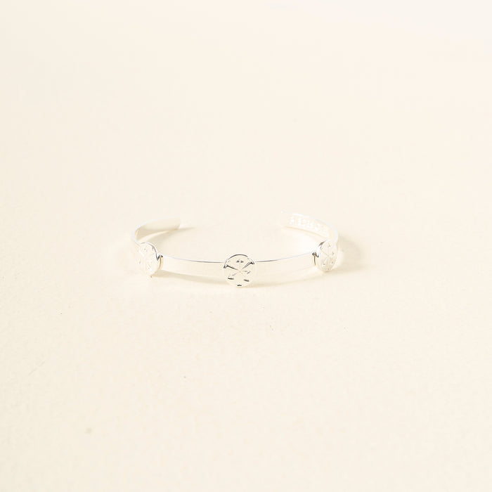 The Darling Effect's "You Are Hard-Working Skinny Stacker Bracelet" is a minimalist silver adjustable cuff with three engraved circles, shown on an off-white background.
