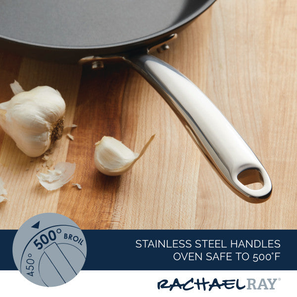 11-Piece Professional Hard-Anodized Nonstick and Induction Stainless Steel Cookware Set with a stainless steel handle beside garlic on a wooden surface, perfect for any kitchen that values quality nonstick cookware.
