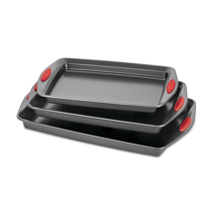 Discover the convenience of the 3-Piece Nonstick Sheet Pan Set, crafted from durable steel and featuring three stackable baking trays with red silicone grips. Oven safe for worry-free baking, these trays make cleanup a breeze every time.
