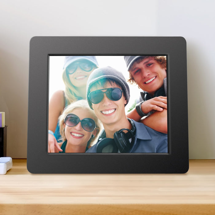 Black digital photo frame showing a group photo on the screen