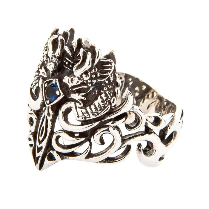 Side view of handcrafted sterling silver dragon ring showing intricate filigree scrollwork and blue gemstone