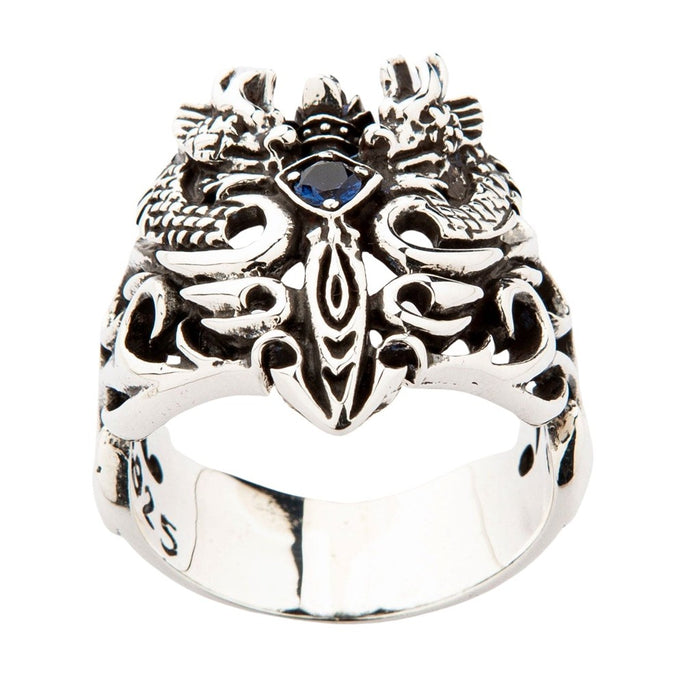 Front view of sterling silver ring featuring twin dragons flanking central sword with blue CZ centerpiece