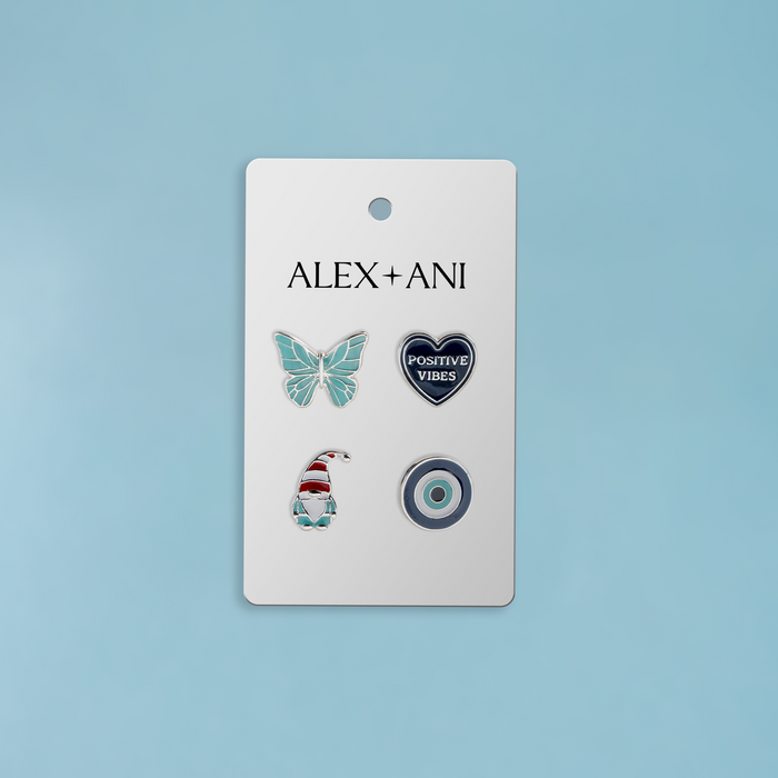 Set of four enamel pins on a 'Alex + Ani' branded card against a light blue background