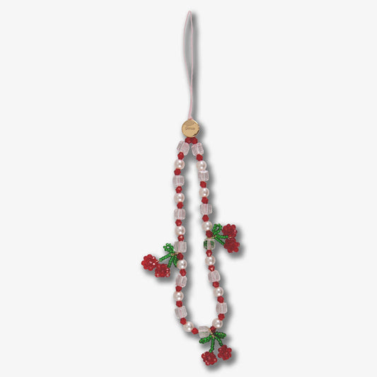 Close up of Beaded Phone Charm Cherry Love showing red and clear beads, pearls and green beaded cherry on white background