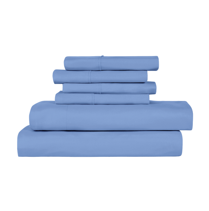 A stack of folded bedding pieces in a dusty medium blue color, arranged neatly on a plain white background.