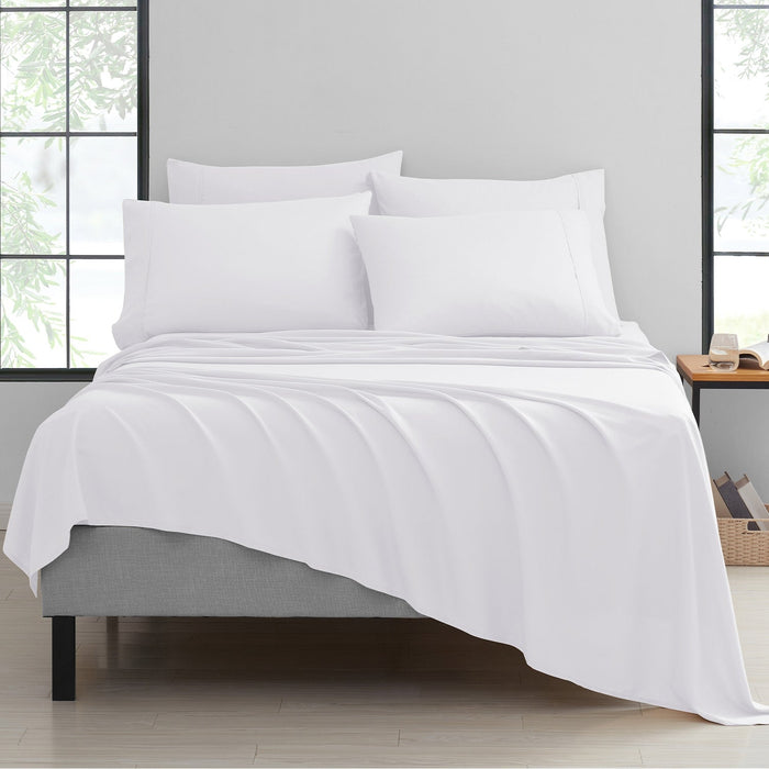 A white 6-piece bamboo sheet set displayed on a bed, including a fitted sheet, flat sheet, and pillowcases.