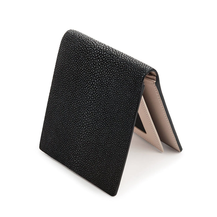 Standing bifold with black shagreen outside and beige cowhide within, a card cutout showing at the fold.