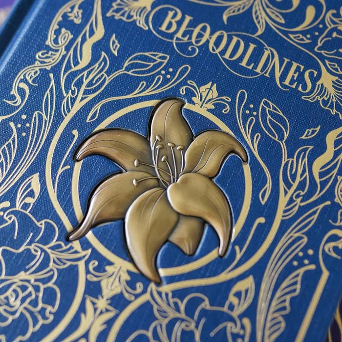 Bloodlines Special Edition Box Set by Richelle Mead – close-up of navy blue book cover with raised gold lily emblem and ornate gold floral line art