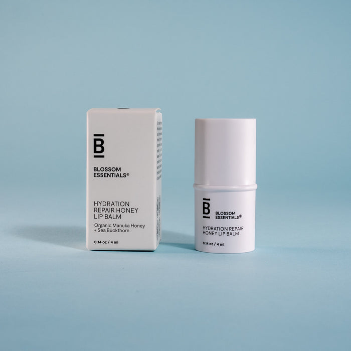 Blossom Essentials lip balm packaging on a light blue background