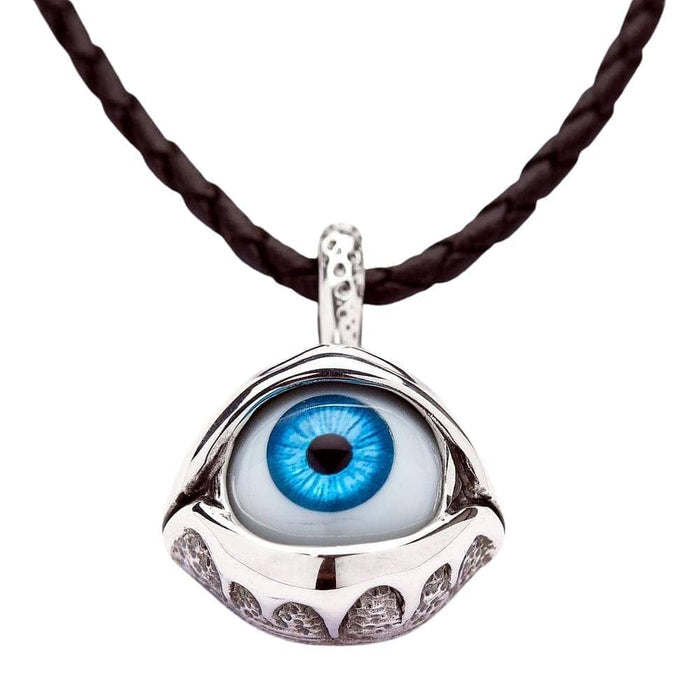 A sterling silver blue eyeball pendant with sculpted eyelids, shown hanging from its included braided leather cord necklace.