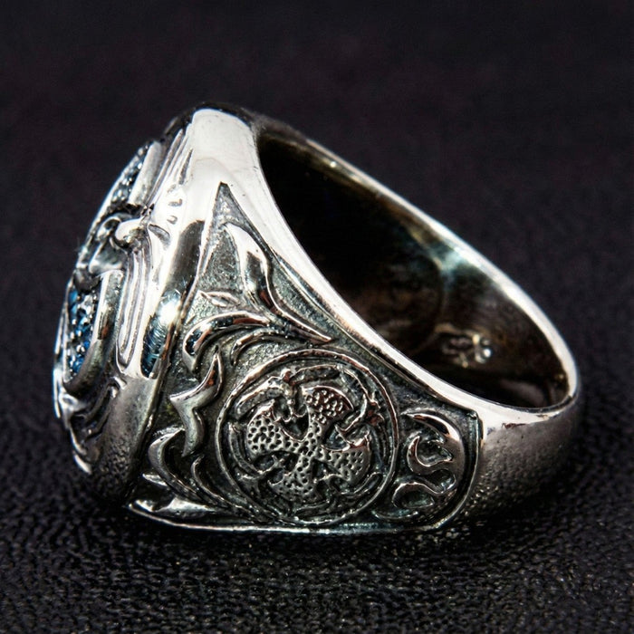 Close-up of the circular heraldic emblem carved into the side panel of the 925 sterling silver ring