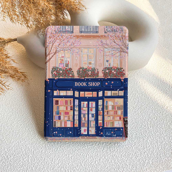 A Kindle case featuring an illustration of a bookshop with a pink and blue color scheme.