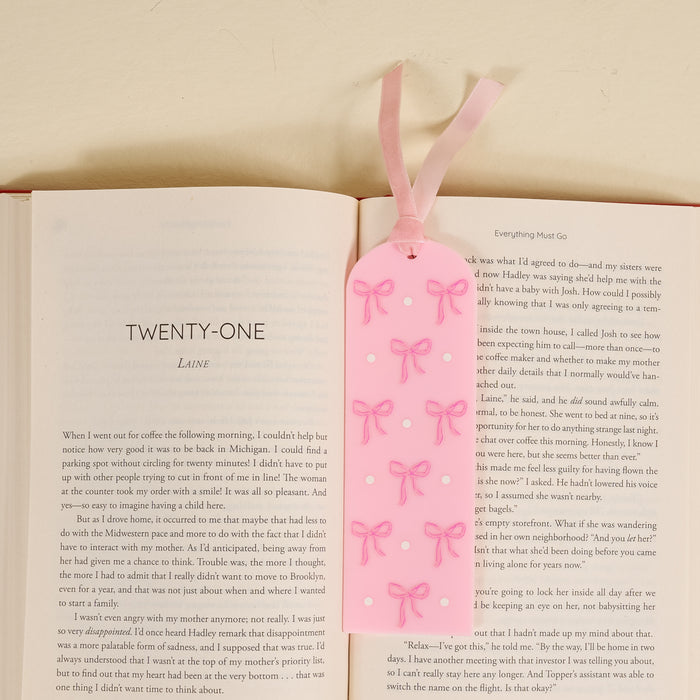 The Bows Pink Acrylic Bookmark by the-darling-effect features a light pink design with cute bows and white dots plus a ribbon—perfect for book lovers or as a charming gift.
