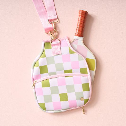 The Darling Effect Check Green Pickleball Paddle Case features a pink and green checkerboard pattern, a pink strap, and room for your favorite paddles.