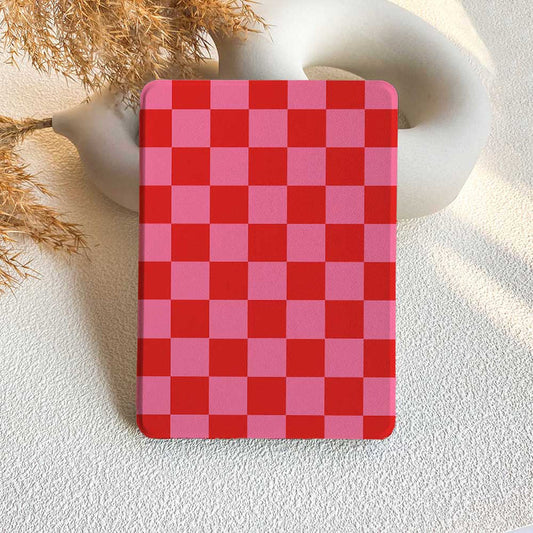 A checkered pattern Kindle case in red and pink, displayed on a white surface.