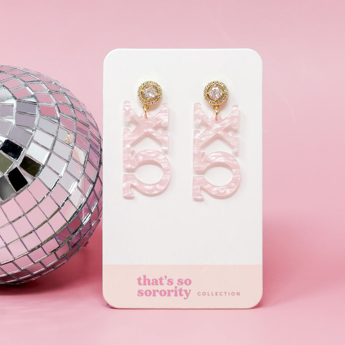 Chi Omega Letter Pink Acrylic Earrings by The Darling Effect feature pink laser-cut acrylic with gold, diamond-accented tops—perfect for your sorority bid day basket.