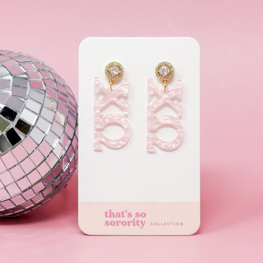 Chi Omega Letter Pink Acrylic Earrings by The Darling Effect feature pink laser-cut acrylic with gold, diamond-accented tops—perfect for your sorority bid day basket.