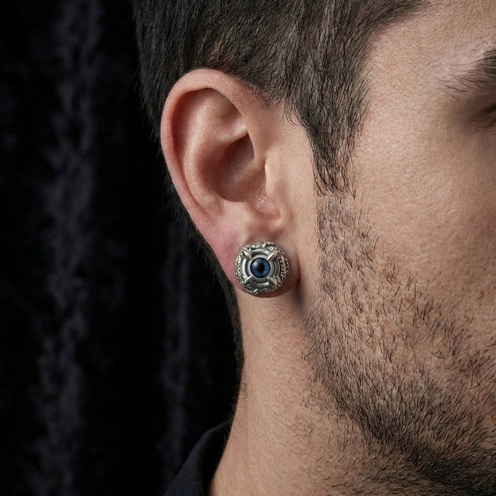 Man wearing claw eyeball sterling silver gothic stud earring showing actual size and fit on earlobe
