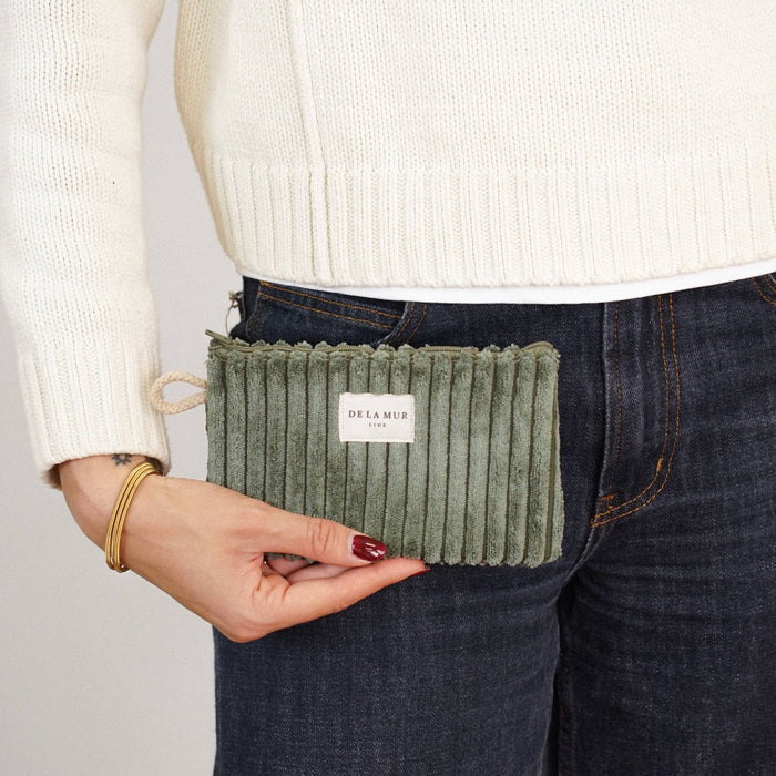 Olive green corduroy small makeup bag from DE LA MUR LINE US Inc, with zipper closure and compact design for cosmetics storage.