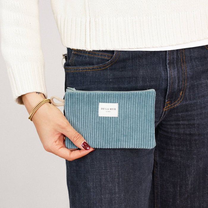 Teal corduroy small makeup bag by DE LA MUR LINE US Inc, stylish pouch with zipper closure and soft textured fabric.