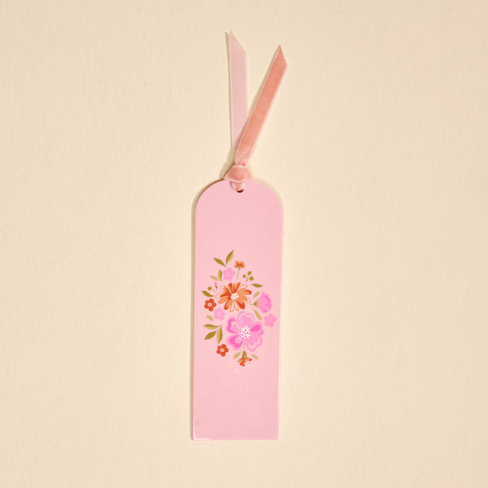 The Dainty Floral Pink Acrylic Bookmark features pink and orange flowers with green leaves and a pink ribbon—an ideal gift or accessory for book lovers.