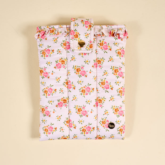 The Endless Daydream Cream Book Cover by the-darling-effect is a cute, puffy polyester cover with a pink and yellow floral print, ruffled top edge, and gold button flap closure, shown on a beige background.
