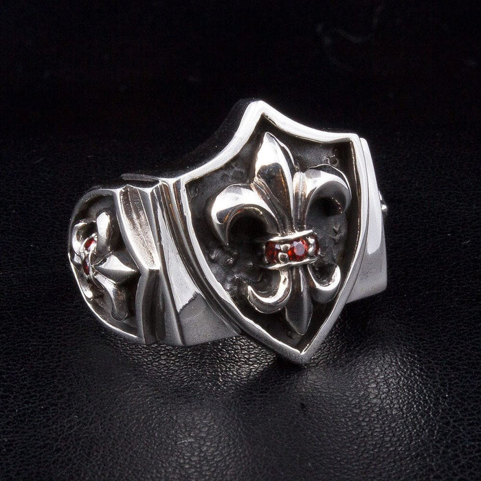 Fleur De Lis sterling silver shield ring with red garnet stones front view