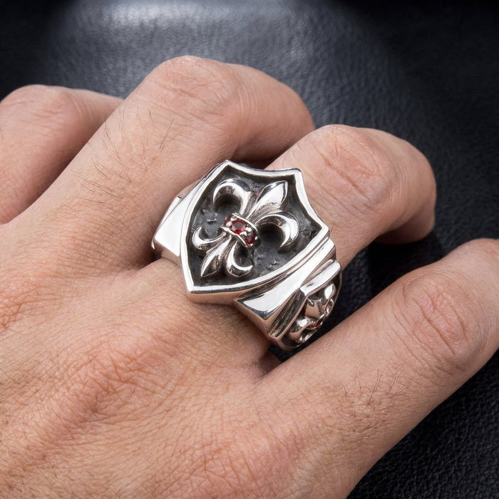 Fleur De Lis sterling silver statement ring with red garnet worn on hand