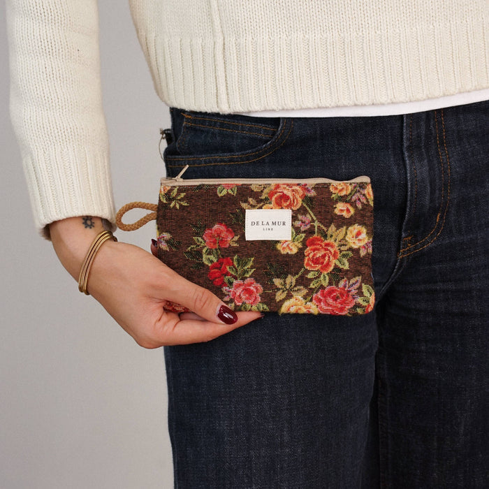 Floral Jacquard small makeup bag in brown and red by DE LA MUR LINE US Inc, showcasing its textured fabric and compact design.