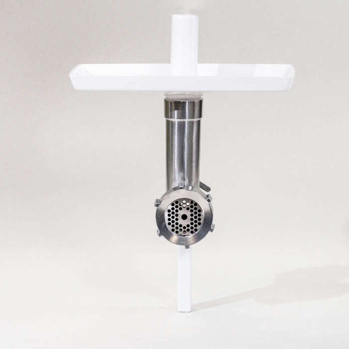 A Bosch meat grinder attachment with a white tray on top, set against a neutral background.