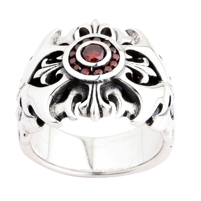Front-facing view of ornate sterling silver ring with red garnet center stone encircled by smaller garnets and filigree cross detailing