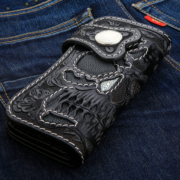 The gray stingray skull inlay side of the long biker wallet, shown on denim.