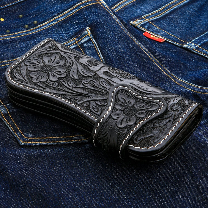 A close-up of the hand-tooled leather strap and silver concho snap.
