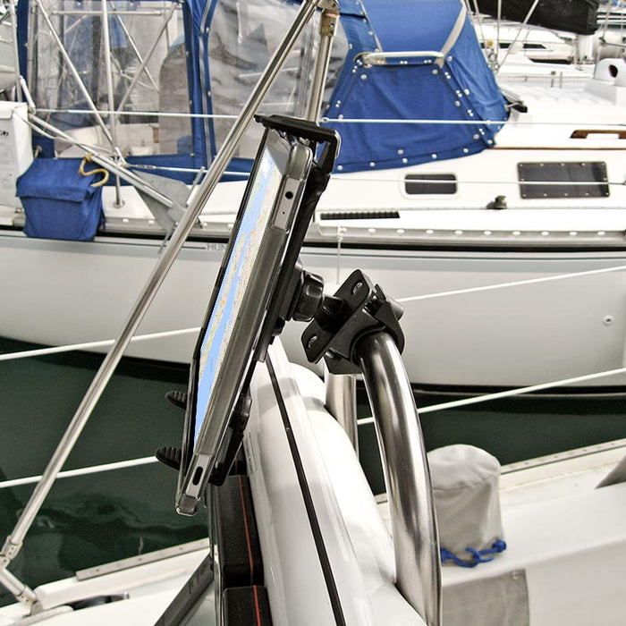 The Handlebar Slim-Grip® Tablet Mount secures an iPad or Note to a boats metal rail, displaying a nautical chart with other boats and blue canvas covers visible in the background.