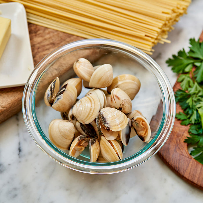 Hardshell clams in a glass bowl.