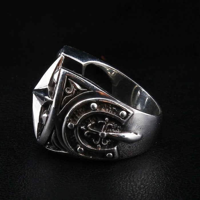 Right side profile of biker horseshoe signet ring showing nautical helm emblem and polished silver band