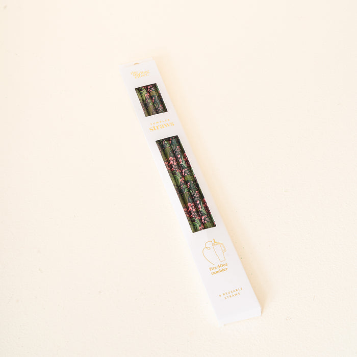 A box of eco-friendly, reusable straws from The Darling Effect, featuring a floral design on the packaging, rests on a white surface. The label reads “Jolly Sprig Green 40 oz Tumbler Straw Set” and displays an illustration of a 40 oz tumbler straw.