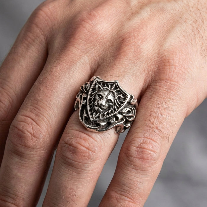 Man wearing a heavy 23-gram silver lion shield ring on a fist, showing scale and impact.