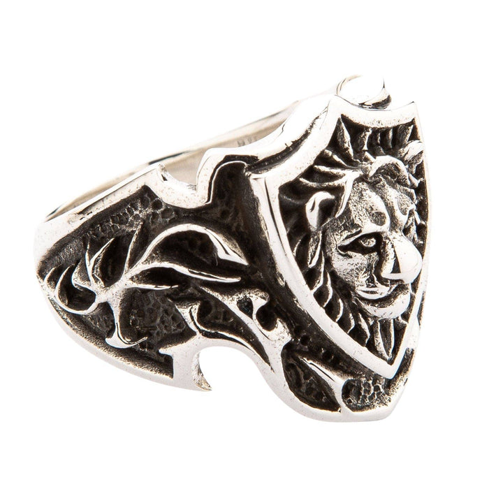 Side view of the ring showing intricate filigree cutout design and thick silver band.