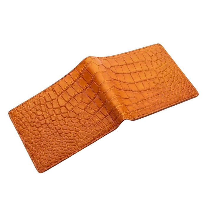 A flat, open view of the handmade crocodile bifold wallet, displaying its full layout.