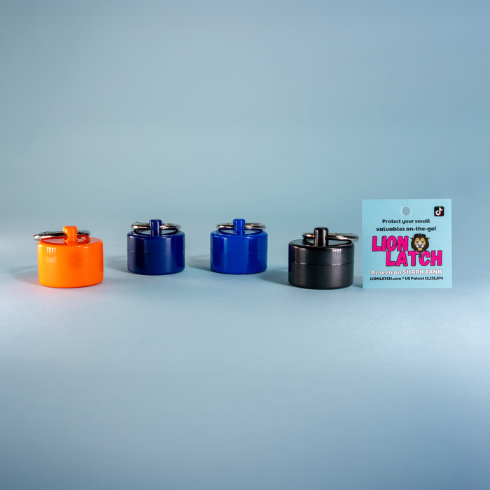 Four cylindrical metal latches in different colors with a Lion Latch branded card on a gray background.