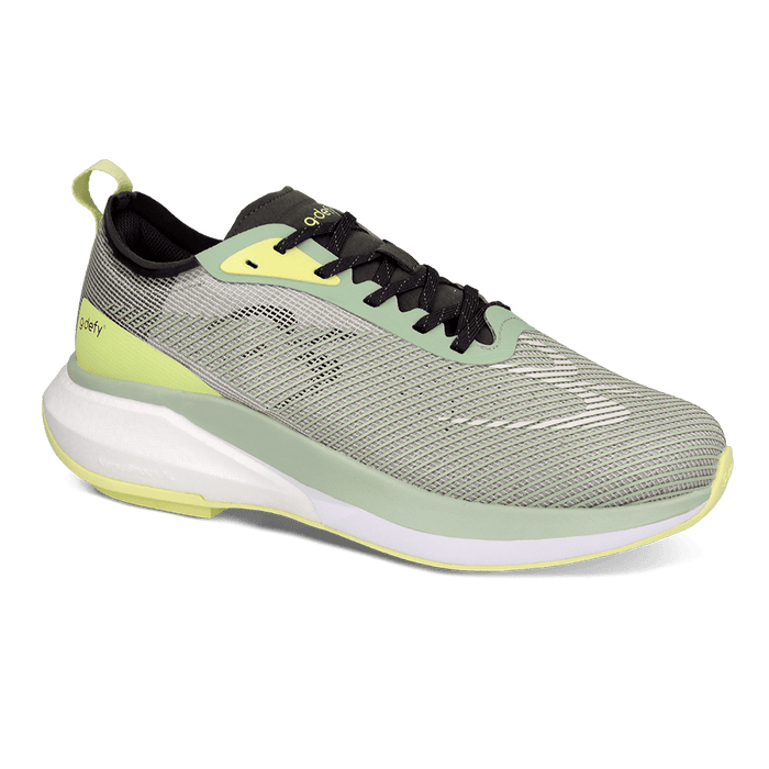 GDefy running shoe in light green mesh with black laces, neon yellow details, and a thick white cushioned sole.