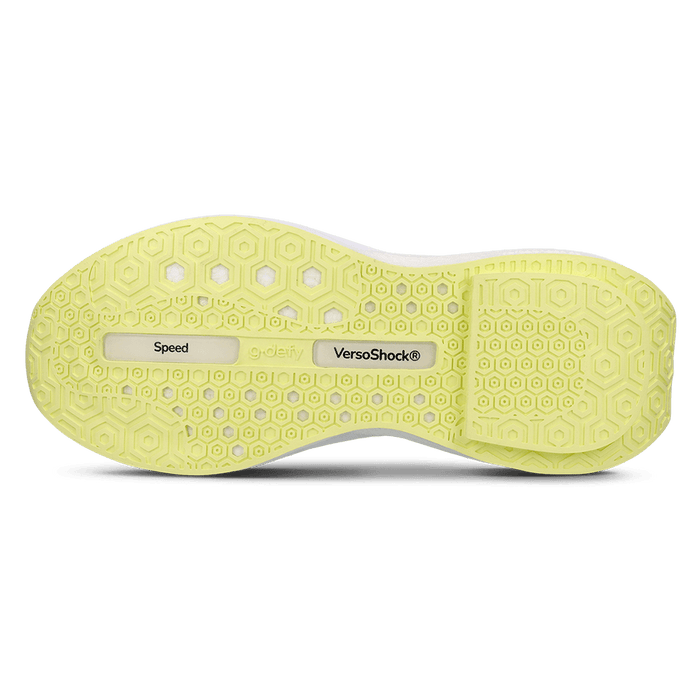 Underside of a white shoe with a light green sole with hexagonal patterns and text
