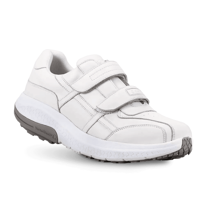 White leather walking shoe featuring three adjustable Velcro straps and a thick white sole with grey accents.