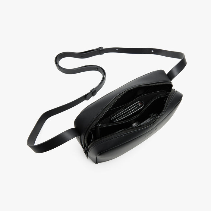 Carbon Black (Vegan Leather) | Angled view of Metro Crossbody in Carbon Black