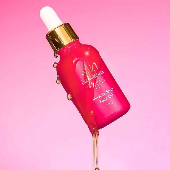 Pink bottle of 'GlowSия' Miracle Elixir Face Oil with dropper on a pink background